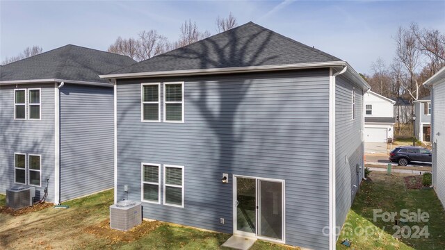 rear view of house featuring central AC unit