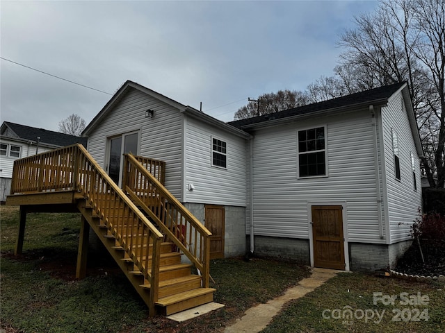 back of property featuring a wooden deck