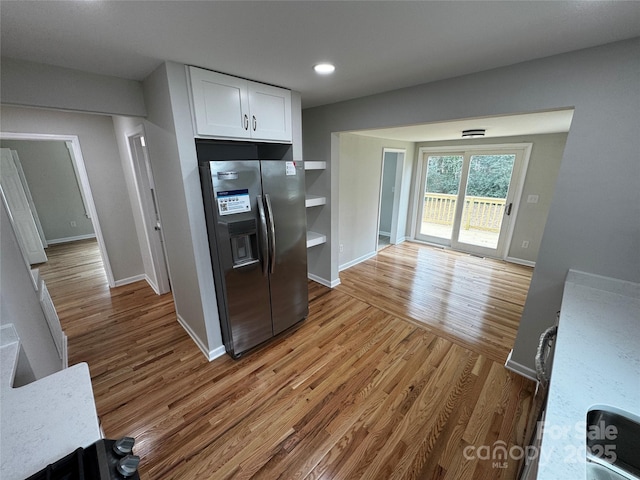 kitchen with hardwood / wood-style flooring, white cabinetry, and stainless steel fridge with ice dispenser