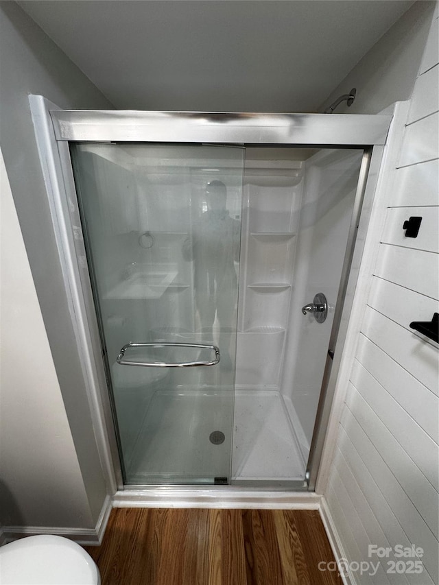 bathroom with walk in shower and hardwood / wood-style flooring