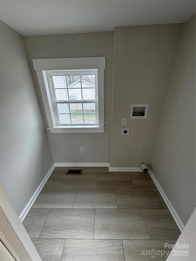 laundry room with hookup for a washing machine, electric dryer hookup, and tile patterned floors