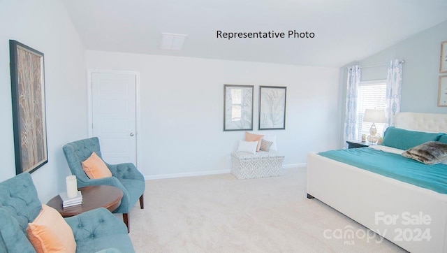 carpeted bedroom with lofted ceiling