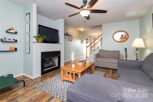 living room featuring dark hardwood / wood-style floors and ceiling fan