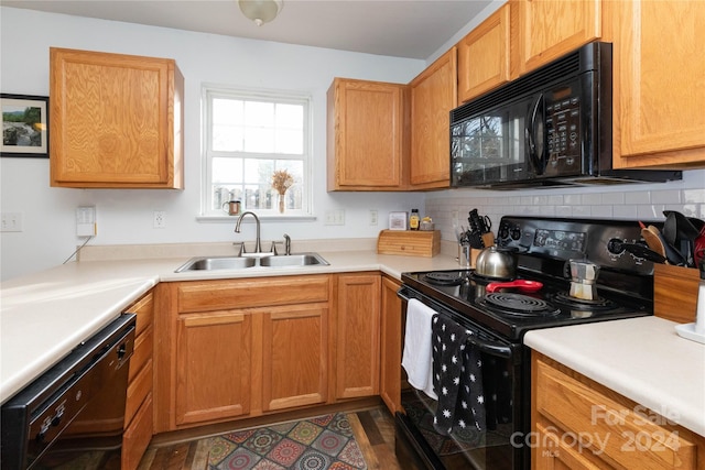 kitchen featuring decorative backsplash, dark hardwood / wood-style flooring, sink, and black appliances