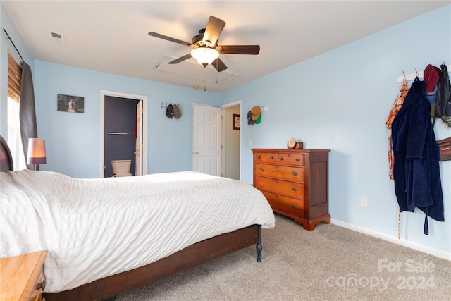 bedroom featuring ceiling fan, carpet floors, and ensuite bath