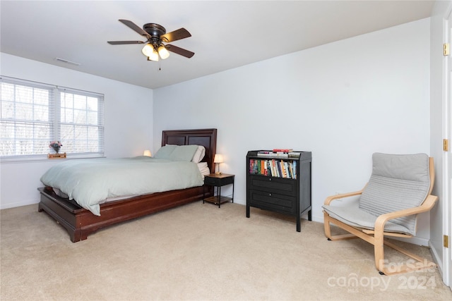 bedroom with light colored carpet and ceiling fan