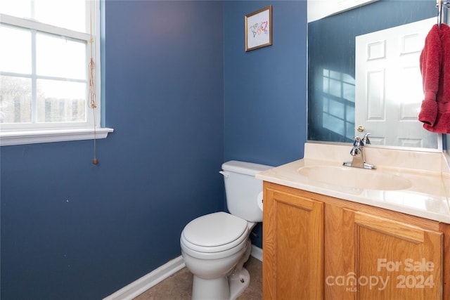 bathroom featuring tile patterned flooring, vanity, and toilet