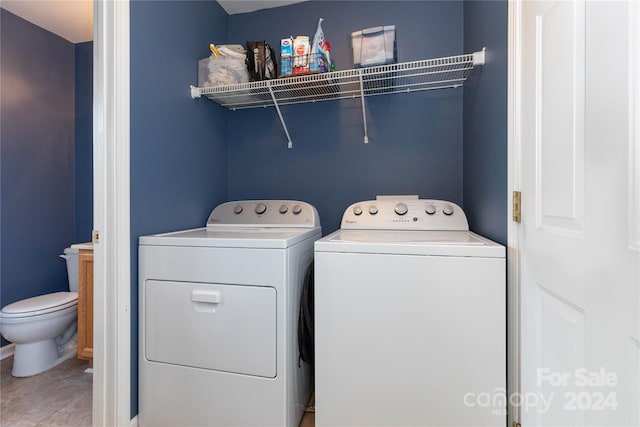 laundry room with tile patterned flooring and separate washer and dryer