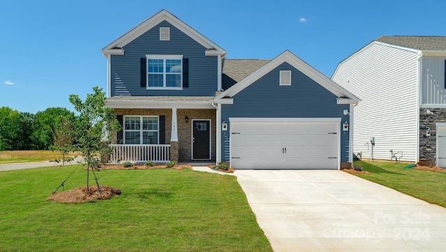 craftsman-style house featuring covered porch, a front yard, and a garage