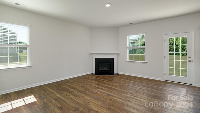 unfurnished living room with dark wood-type flooring