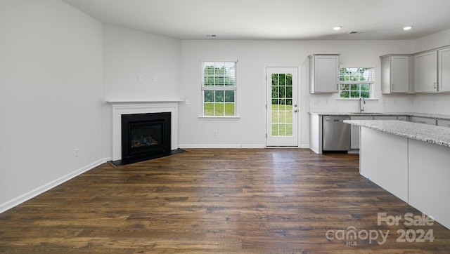 unfurnished living room with dark hardwood / wood-style floors and sink