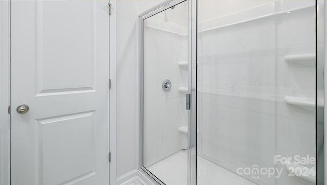 bathroom featuring a shower with shower door