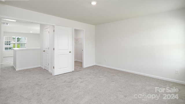 unfurnished room with light carpet