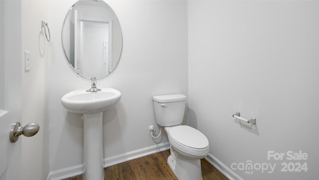 bathroom featuring sink, hardwood / wood-style floors, and toilet