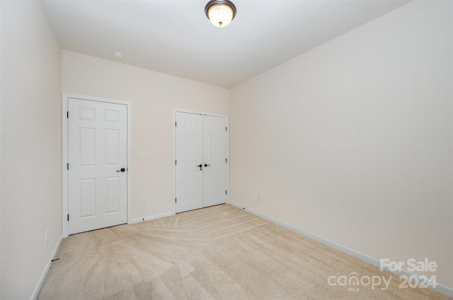 unfurnished bedroom with light carpet