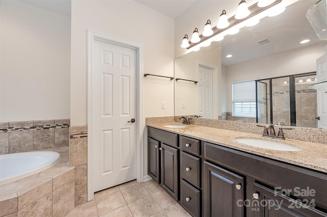 bathroom with tile patterned flooring, vanity, and independent shower and bath