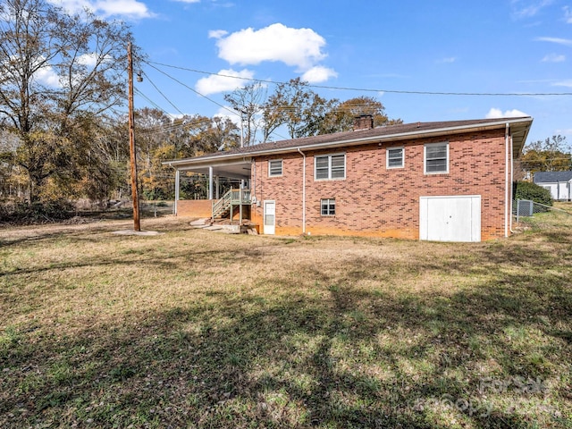 back of property with a lawn