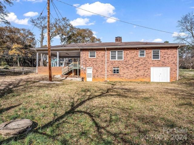 back of house with a lawn