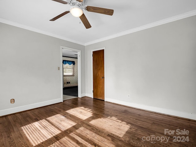 unfurnished room featuring dark hardwood / wood-style floors, ceiling fan, and ornamental molding