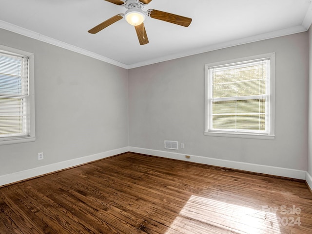 spare room featuring a wealth of natural light, ceiling fan, wood-type flooring, and ornamental molding