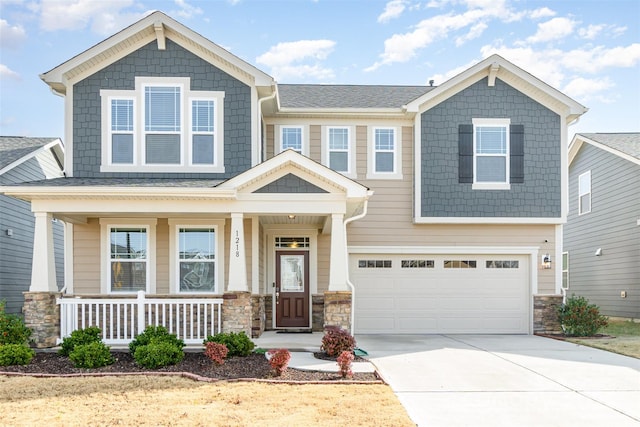 craftsman-style house featuring covered porch and a garage