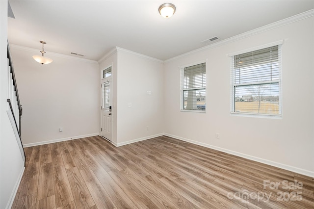 empty room with crown molding and wood-type flooring