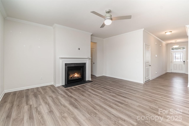 unfurnished living room with crown molding, ceiling fan, and light hardwood / wood-style flooring