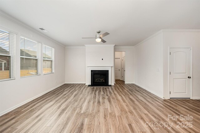 unfurnished living room with ornamental molding, ceiling fan, and light wood-type flooring