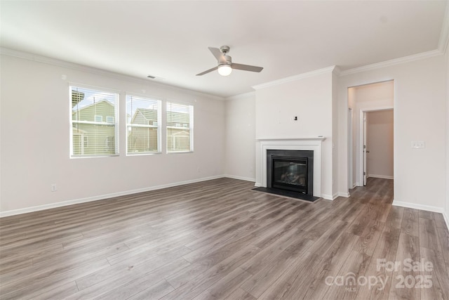 unfurnished living room with ceiling fan, light wood-type flooring, and crown molding