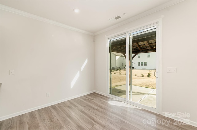 spare room featuring light hardwood / wood-style flooring and crown molding