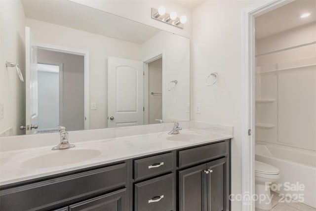 full bathroom with toilet, tile patterned flooring, washtub / shower combination, and vanity