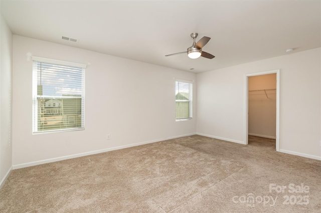 unfurnished room featuring light carpet and ceiling fan