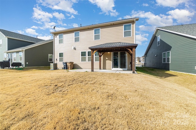 back of house with a patio area and a yard