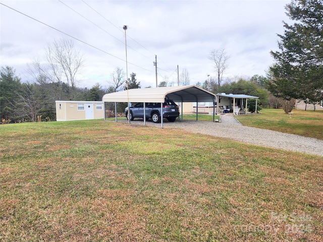 view of yard featuring a carport and a storage unit