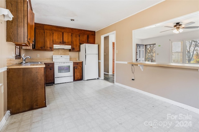 kitchen featuring white appliances, ceiling fan, and sink