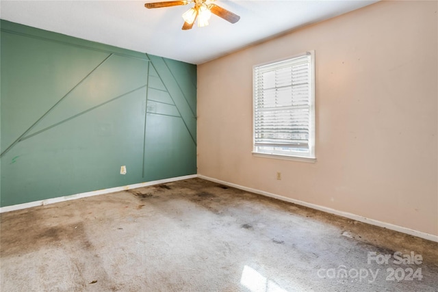 spare room featuring carpet flooring and ceiling fan