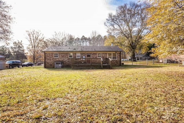 rear view of house with a yard and a deck