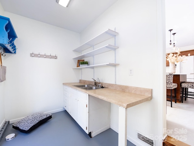 clothes washing area with sink