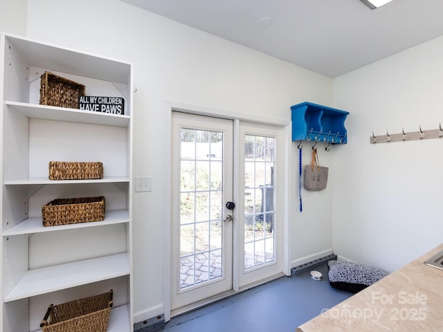 doorway to outside with concrete floors