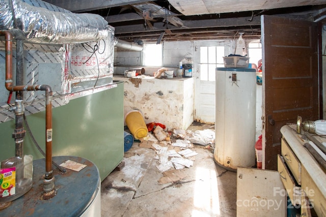 basement featuring gas water heater and heating unit