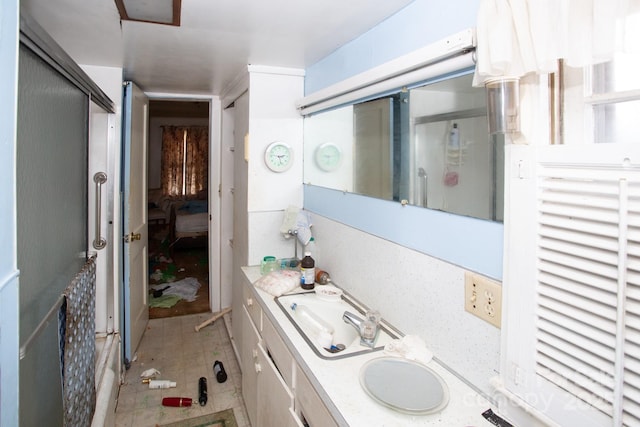 bathroom with vanity and a shower with shower door