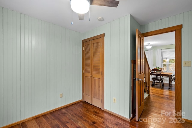 interior space with dark hardwood / wood-style flooring and ceiling fan