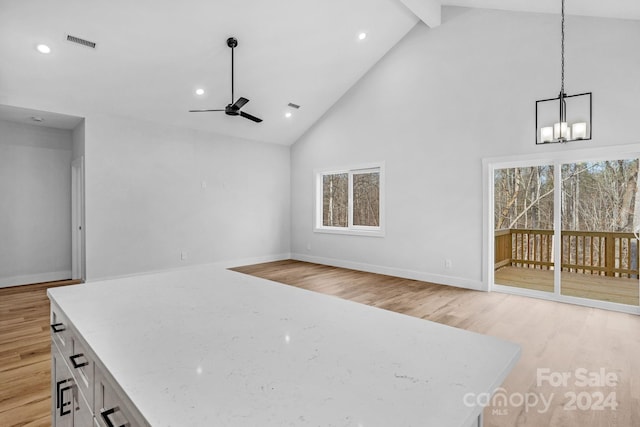 interior space featuring white cabinetry, plenty of natural light, decorative light fixtures, and light wood-type flooring