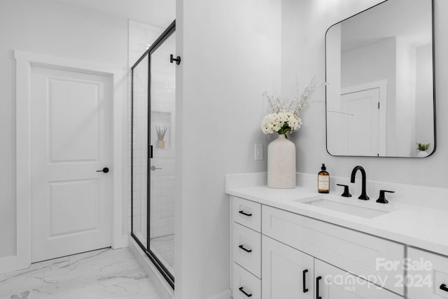 bathroom featuring vanity and a shower with shower door