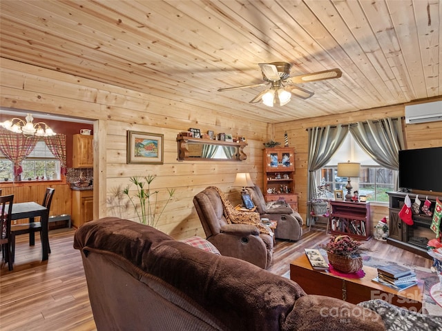 living room featuring a wall mounted air conditioner, ceiling fan with notable chandelier, wooden walls, wood-type flooring, and wood ceiling