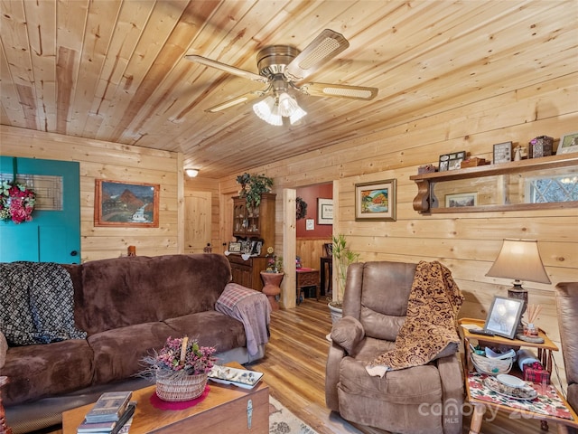 living room with wood ceiling, wooden walls, ceiling fan, and light hardwood / wood-style floors