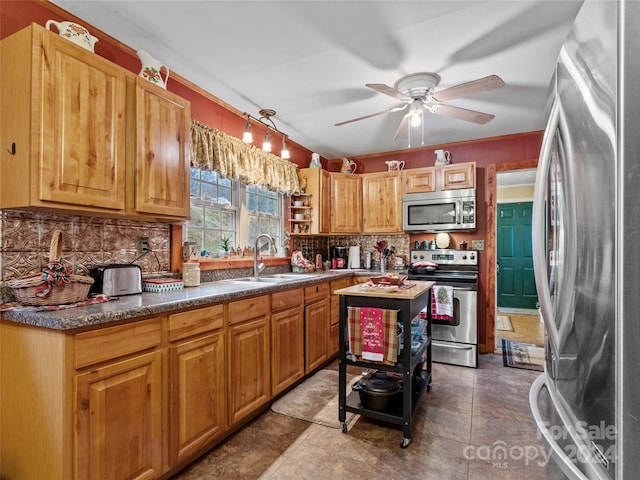 kitchen featuring ceiling fan, sink, backsplash, and appliances with stainless steel finishes