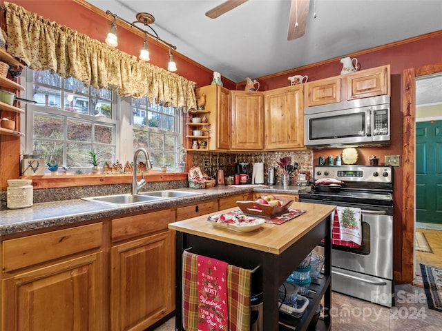 kitchen featuring butcher block counters, sink, stainless steel appliances, backsplash, and ornamental molding