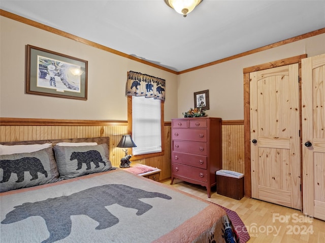 bedroom with hardwood / wood-style floors, wood walls, and crown molding