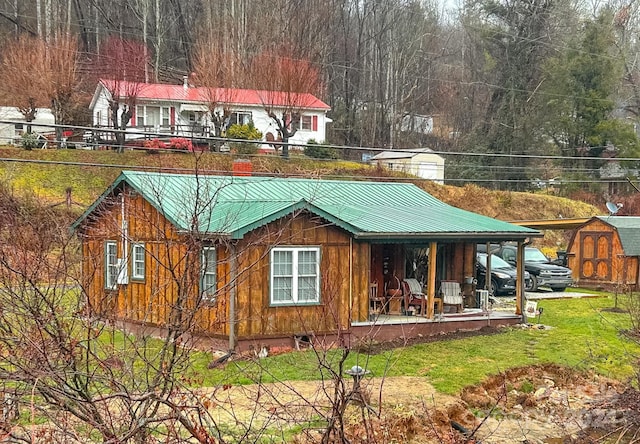 back of property featuring covered porch